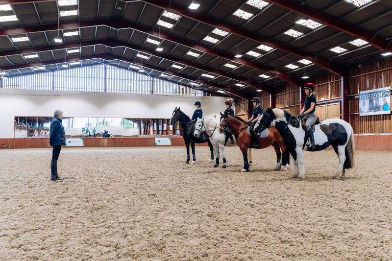 Instructor teaching a group of riders